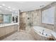 Spa-like bathroom featuring a large soaking tub and walk-in shower at 675 Longboat Club Rd # 22A, Longboat Key, FL 34228