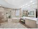 Elegant bathroom with soaking tub, double vanity, and walk-in shower at 675 Longboat Club Rd # 22A, Longboat Key, FL 34228