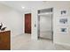 Elegant entryway with wood door and elevator access at 675 Longboat Club Rd # 22A, Longboat Key, FL 34228