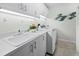 Bright laundry room with white cabinets and modern appliances at 675 Longboat Club Rd # 22A, Longboat Key, FL 34228