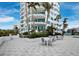 White patio furniture on a stone patio at 675 Longboat Club Rd # 22A, Longboat Key, FL 34228