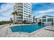 Relaxing pool area with building in background at 675 Longboat Club Rd # 22A, Longboat Key, FL 34228