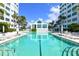 Refreshing pool and clubhouse with lounge chairs at 675 Longboat Club Rd # 22A, Longboat Key, FL 34228