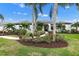 White two-story house with gray roof, landscaping, and walkway at 7117 River Club Blvd, Bradenton, FL 34202