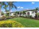 White house with gray roof, landscaping, walkway, and palm trees at 7117 River Club Blvd, Bradenton, FL 34202