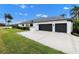 Two-car garage with dark gray doors and paved driveway at 7117 River Club Blvd, Bradenton, FL 34202