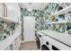 Bright laundry room with stylish tropical wallpaper and quartz countertops at 7117 River Club Blvd, Bradenton, FL 34202