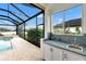 Outdoor kitchen with a sink and cabinets, perfect for entertaining at 7117 River Club Blvd, Bradenton, FL 34202