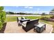 Patio with fire pit and seating area overlooking lake at 7117 River Club Blvd, Bradenton, FL 34202