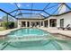 Inviting pool area with covered patio and lush landscaping at 7117 River Club Blvd, Bradenton, FL 34202