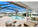 Resort-style pool and patio with covered seating area and lake view at 7117 River Club Blvd, Bradenton, FL 34202