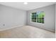 Well-lit bedroom featuring tile floors and a large window at 7417 Vista Way # 106, Bradenton, FL 34202