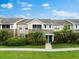 Tan townhome with green door and tropical landscaping at 7417 Vista Way # 106, Bradenton, FL 34202