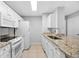 White cabinets, granite counters and appliances at 7417 Vista Way # 106, Bradenton, FL 34202