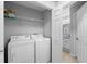 Stackable washer and dryer in a bright laundry room with access to bathroom at 7417 Vista Way # 106, Bradenton, FL 34202