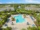 Community pool with lounge chairs and patio tables at 7417 Vista Way # 106, Bradenton, FL 34202