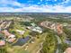 Aerial view showing home location in a community near a golf course and water at 7716 Club Ln, Sarasota, FL 34238