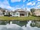 House's back view with a water view, highlighting its waterfront location and backyard at 7716 Club Ln, Sarasota, FL 34238