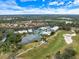 Aerial view of a home on a golf course with a lake nearby at 7716 Club Ln, Sarasota, FL 34238