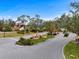 Gated entrance to community with landscaping and fountain at 7716 Club Ln, Sarasota, FL 34238