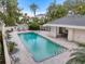 Community pool with lounge chairs and patio area at 7716 Club Ln, Sarasota, FL 34238