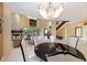 Formal dining room with a round table and modern chandelier at 7716 Club Ln, Sarasota, FL 34238