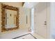 Elegant entryway, featuring a large ornate mirror and white door at 7716 Club Ln, Sarasota, FL 34238