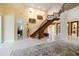 Bright entryway with curved staircase and high ceilings at 7716 Club Ln, Sarasota, FL 34238