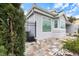 House exterior with gray walls, paver driveway, and landscaping at 7716 Club Ln, Sarasota, FL 34238