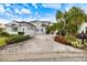 House exterior with paver driveway and landscaping at 7716 Club Ln, Sarasota, FL 34238