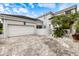 Front exterior of the house, showcasing the driveway, garage, and landscaping at 7716 Club Ln, Sarasota, FL 34238