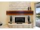 Modern fireplace with a wood mantel and decorative accents at 7716 Club Ln, Sarasota, FL 34238