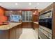 Modern kitchen with granite countertops and a red accent wall at 7716 Club Ln, Sarasota, FL 34238