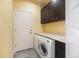 Laundry room with washer, dryer, and cabinets at 7716 Club Ln, Sarasota, FL 34238