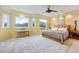 Main bedroom with a king bed and large windows at 7716 Club Ln, Sarasota, FL 34238