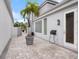 Side yard patio with block pavers and landscaping, offering additional outdoor space at 7716 Club Ln, Sarasota, FL 34238