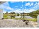 Covered patio overlooking a serene pond and golf course at 7716 Club Ln, Sarasota, FL 34238