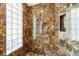 Spa-like shower with marble walls and a built-in bench at 7716 Club Ln, Sarasota, FL 34238