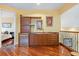 Bonus room wet bar with wood cabinets and fridge at 7716 Club Ln, Sarasota, FL 34238