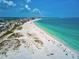 Aerial view of the beautiful white sand beach and turquoise ocean waters at 800 Benjamin Franklin Dr # 602, Sarasota, FL 34236