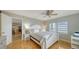 Cozy bedroom with a white wooden bed frame and wood floors at 800 Benjamin Franklin Dr # 602, Sarasota, FL 34236