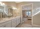 Bathroom with double vanity, view of bedroom, and modern fixtures at 8052 Grande Shores Dr, Sarasota, FL 34240