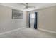 Bedroom with ceiling fan, window, and grey carpet at 8052 Grande Shores Dr, Sarasota, FL 34240