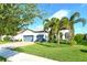 Two-story house with gray-blue garage doors and palm trees at 8052 Grande Shores Dr, Sarasota, FL 34240