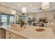 Modern kitchen with white cabinets and a large island overlooking the living room at 8052 Grande Shores Dr, Sarasota, FL 34240