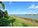 Serene lake view with lush landscaping and homes in background at 8052 Grande Shores Dr, Sarasota, FL 34240