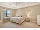 Spacious main bedroom with a large bed, ample natural light, and water views at 8052 Grande Shores Dr, Sarasota, FL 34240