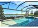 Inviting swimming pool and spa with a screened enclosure at 8052 Grande Shores Dr, Sarasota, FL 34240