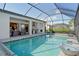 Large swimming pool with screened enclosure and lake view at 8052 Grande Shores Dr, Sarasota, FL 34240