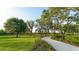 Curved concrete walkway through lush landscaping at 8052 Grande Shores Dr, Sarasota, FL 34240